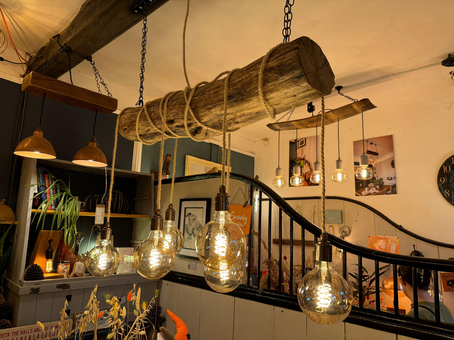 Rustic oak wrap-around chandelier by MooBoo Home featuring warm wood tones and elegant design, hanging from a ceiling with soft lighting.