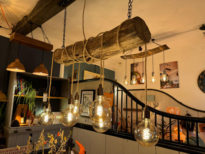 Rustic oak wrap-around chandelier by MooBoo Home featuring warm wood tones and elegant design, hanging from a ceiling with soft lighting.