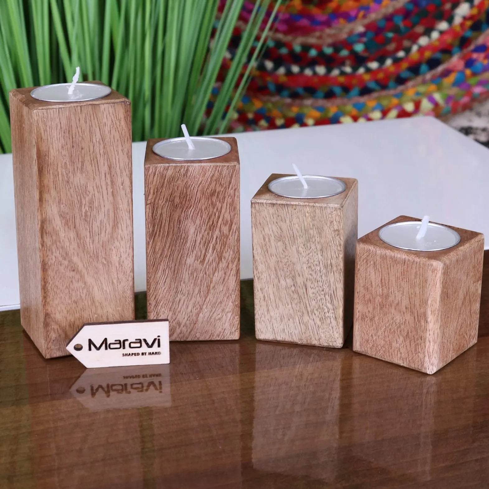 Set of four Bure wooden candle holders by Maravi, featuring natural wood finish and simple design for tea light candles.