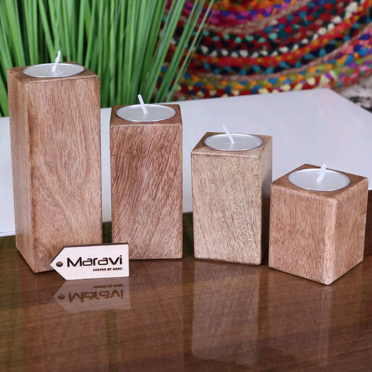Set of four Bure wooden candle holders by Maravi, featuring natural wood finish and simple design for tea light candles.