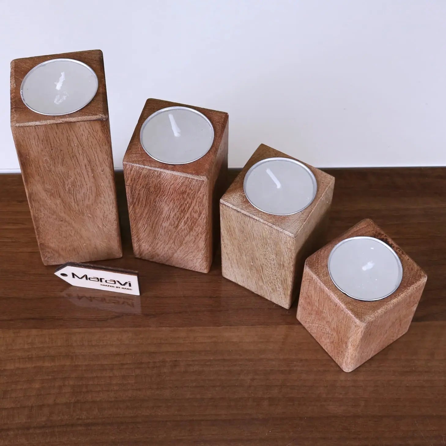 Set of four Bure wooden tea light holders by Maravi, featuring a rustic design perfect for cozy home décor.