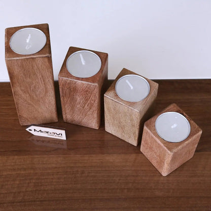 Set of four Bure wooden tea light holders by Maravi, featuring a rustic design perfect for cozy home décor.
