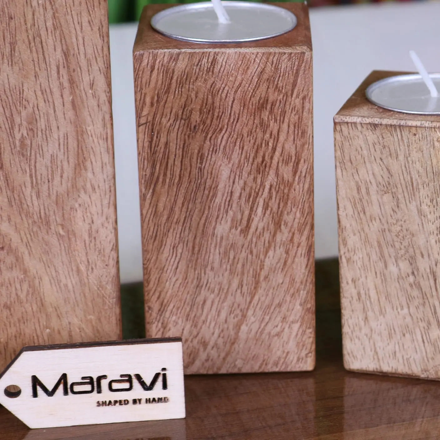 Set of four Bure wooden candle holders by Maravi, showcasing sleek cylindrical design for tea light candles.