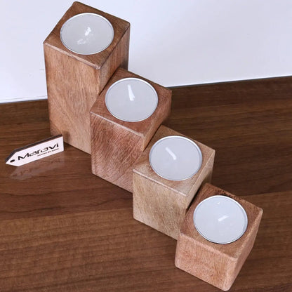Set of four Bure wooden candle holders by Maravi, featuring rustic design and natural wood finish for cozy ambiance.