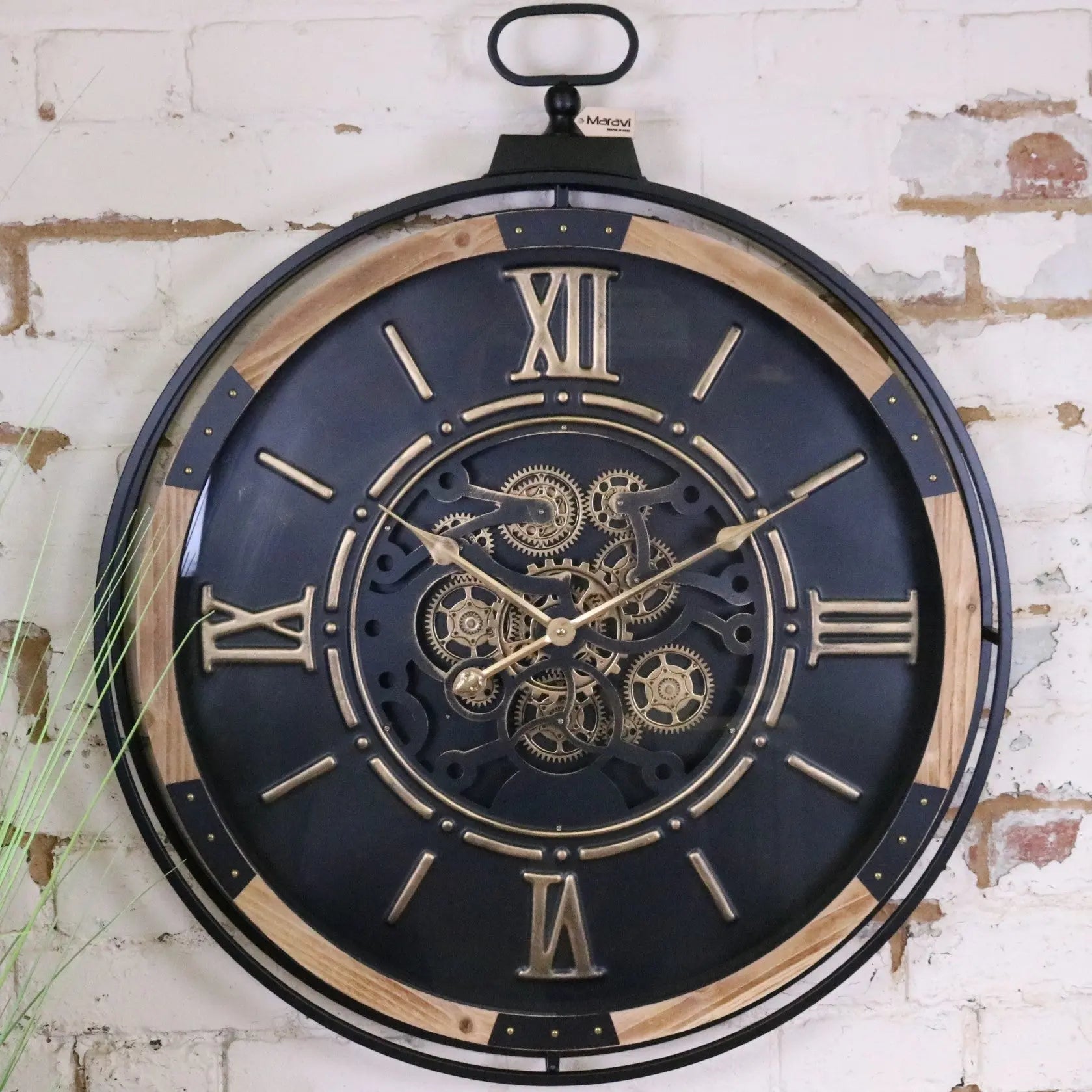 Large industrial wall clock by Maravi featuring a black and gold cog design with bold, vintage-inspired style.