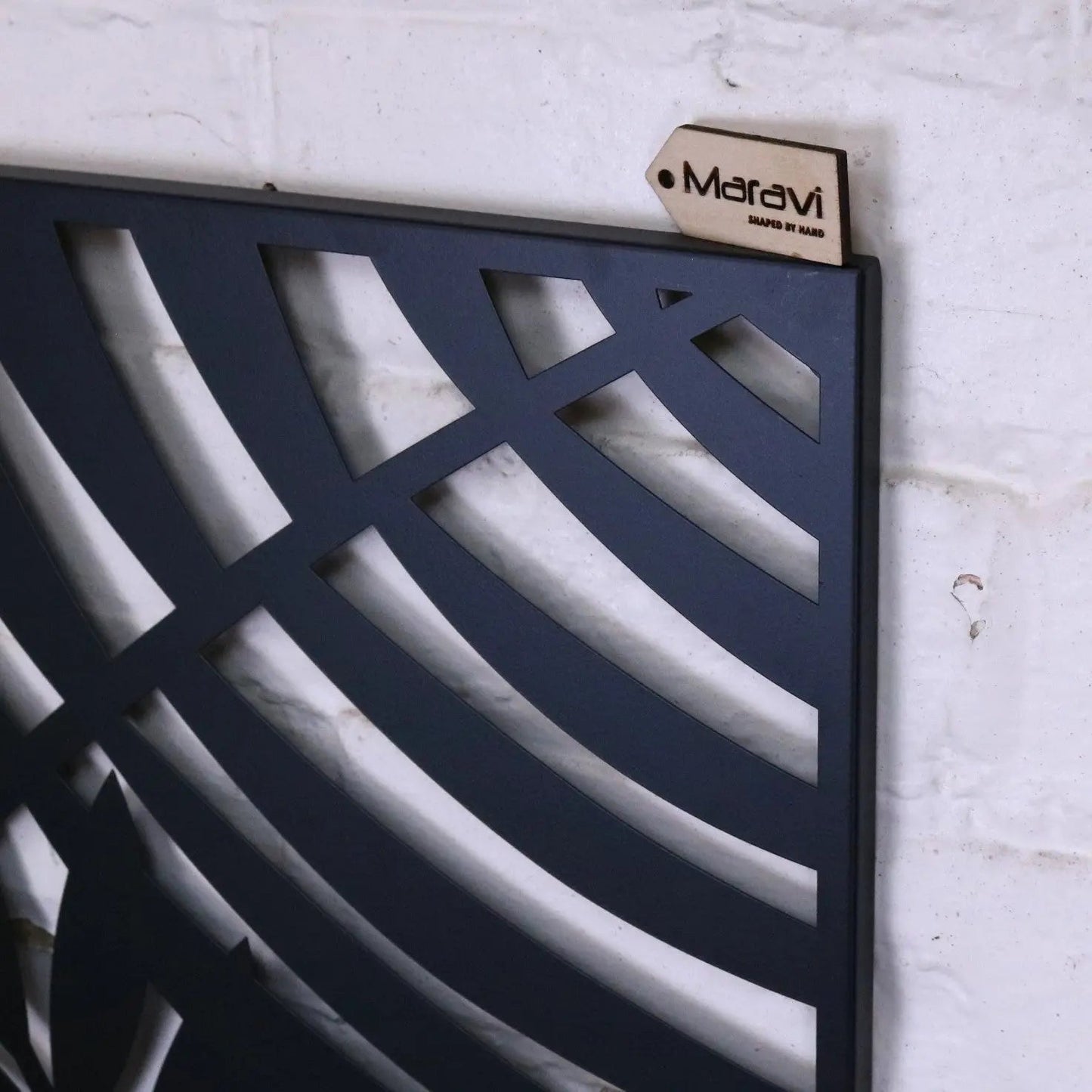 Black metal wall art featuring a leaf design by Maravi, showcasing intricate leaf shapes and a modern, artistic wall decor piece.