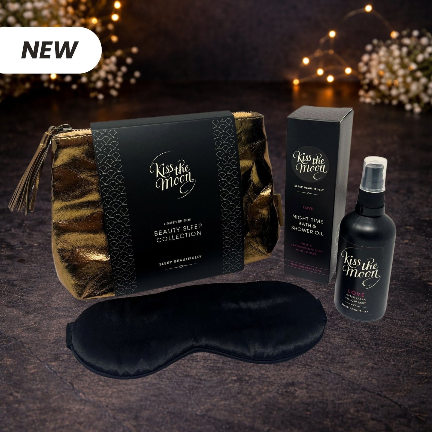 Kiss the Moon limited edition gift set featuring night-time bath oil, pillow mist, silk eye mask, gold makeup bag, and shower oil.