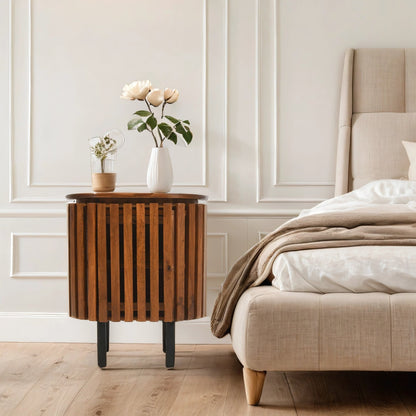 Verty Furniture Compton mango wood bedside table with sleek design, shown in a stylish bedroom setting.
