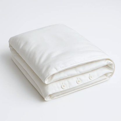 Organic cotton percale bed sheet set from Ethical Bedding™ with neatly folded duvet cover and matching pillowcases.