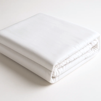 Organic cotton percale fitted bed sheet from Ethical Bedding™, soft and breathable, shown on a neatly made bed.