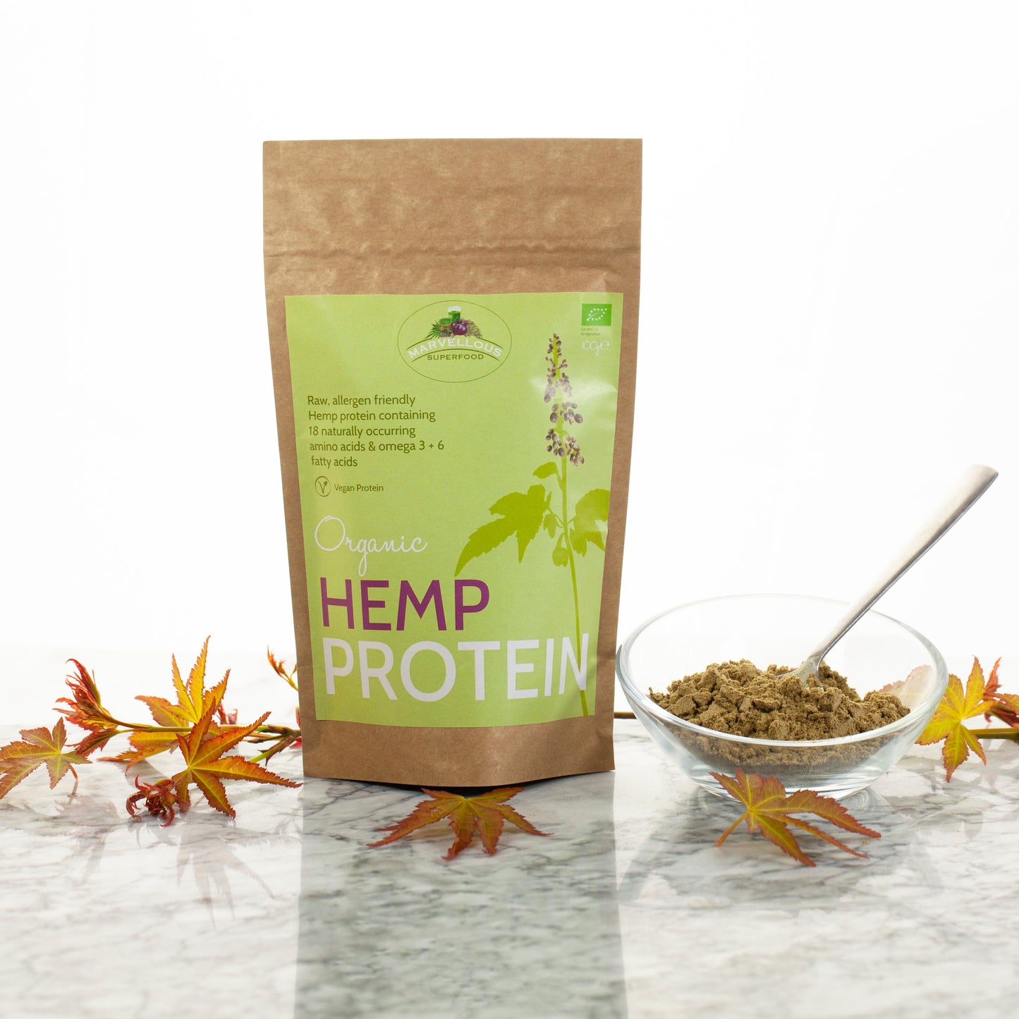Organic hemp protein powder from marvelloussuperfood, showing a scoop of the superfood supplement in a natural setting.