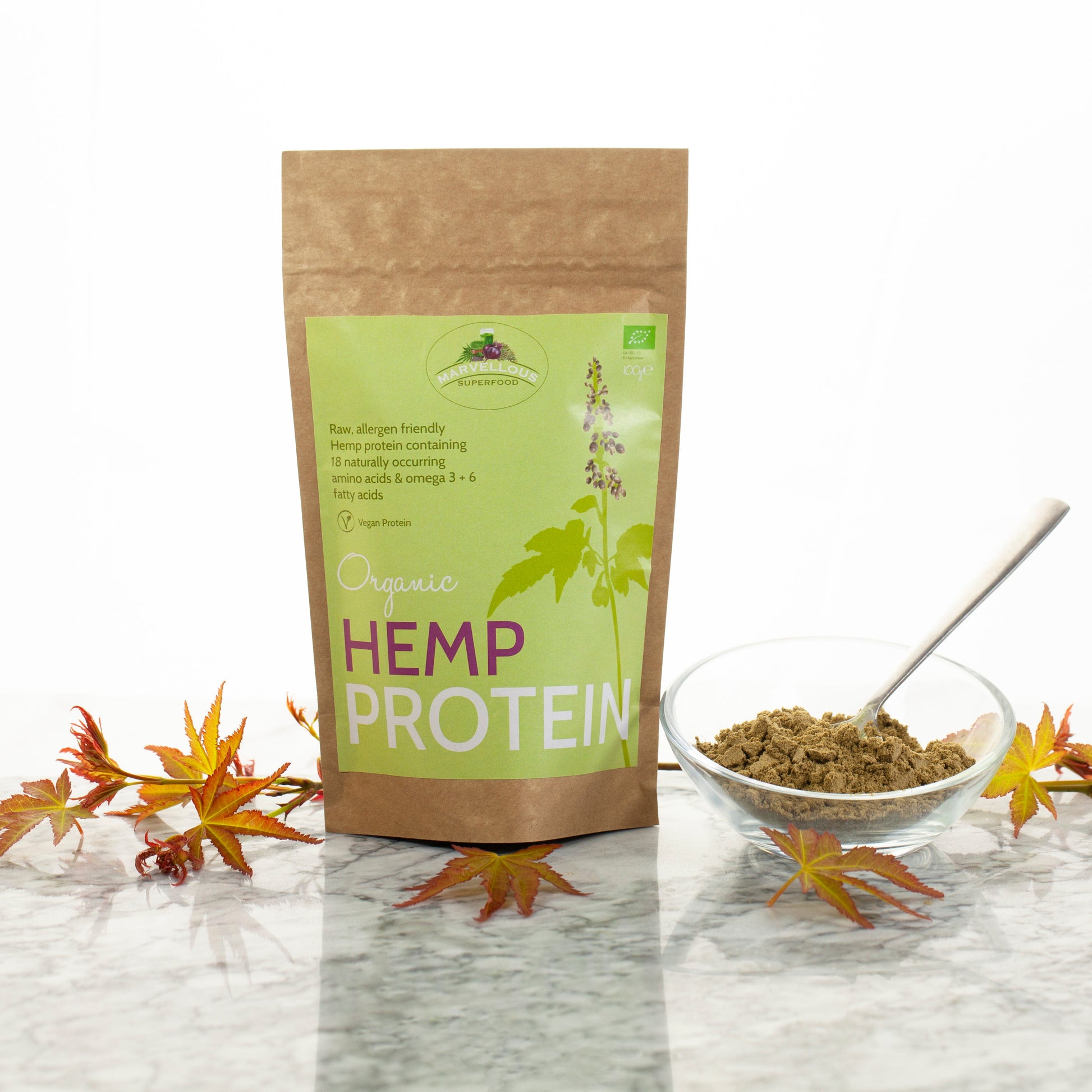 Organic hemp protein powder from marvelloussuperfood, showing a scoop of the superfood supplement in a natural setting.