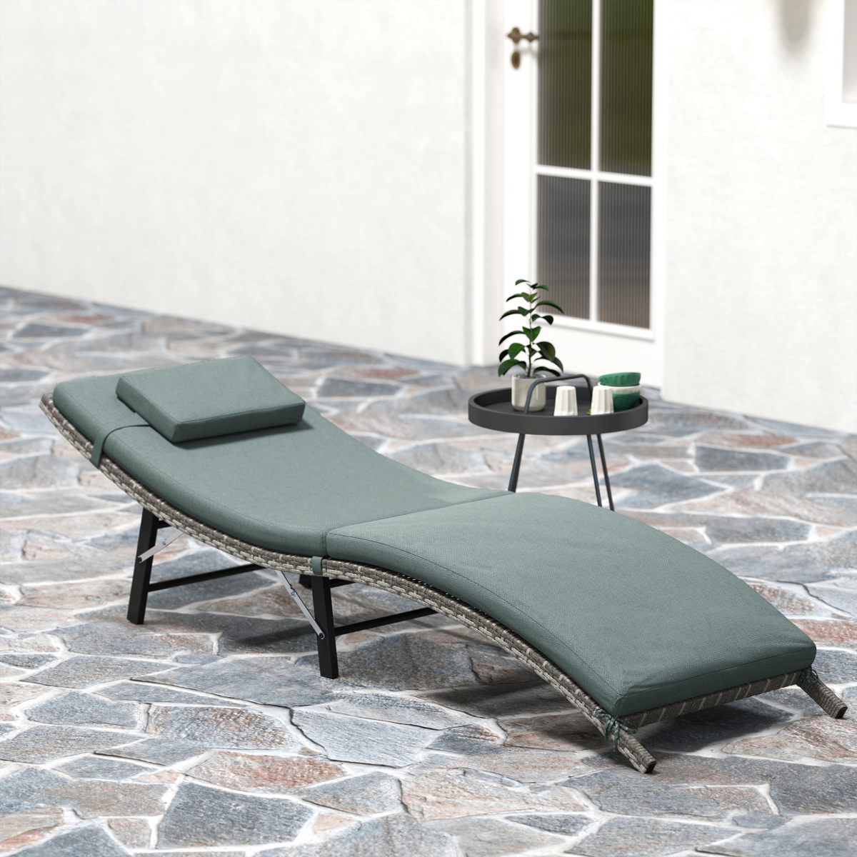 Outsunny folding rattan sun lounger with cushion and pillow, perfect for garden relaxation and outdoor lounging.