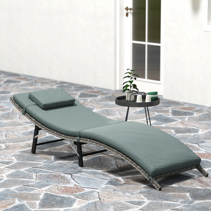 Outsunny folding rattan sun lounger with cushion and pillow, perfect for garden relaxation and outdoor lounging.
