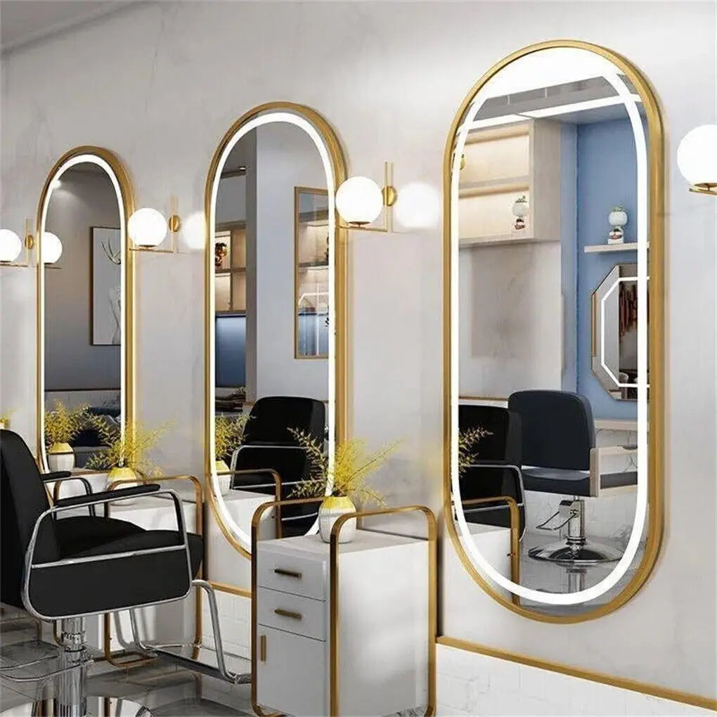 Salon interior with large mirrors and black chairs