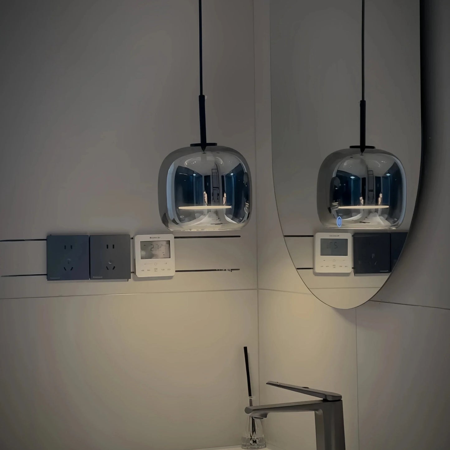 Black and gold pendant lamp with LED warm light and adjustable height, designed for modern interior lighting.