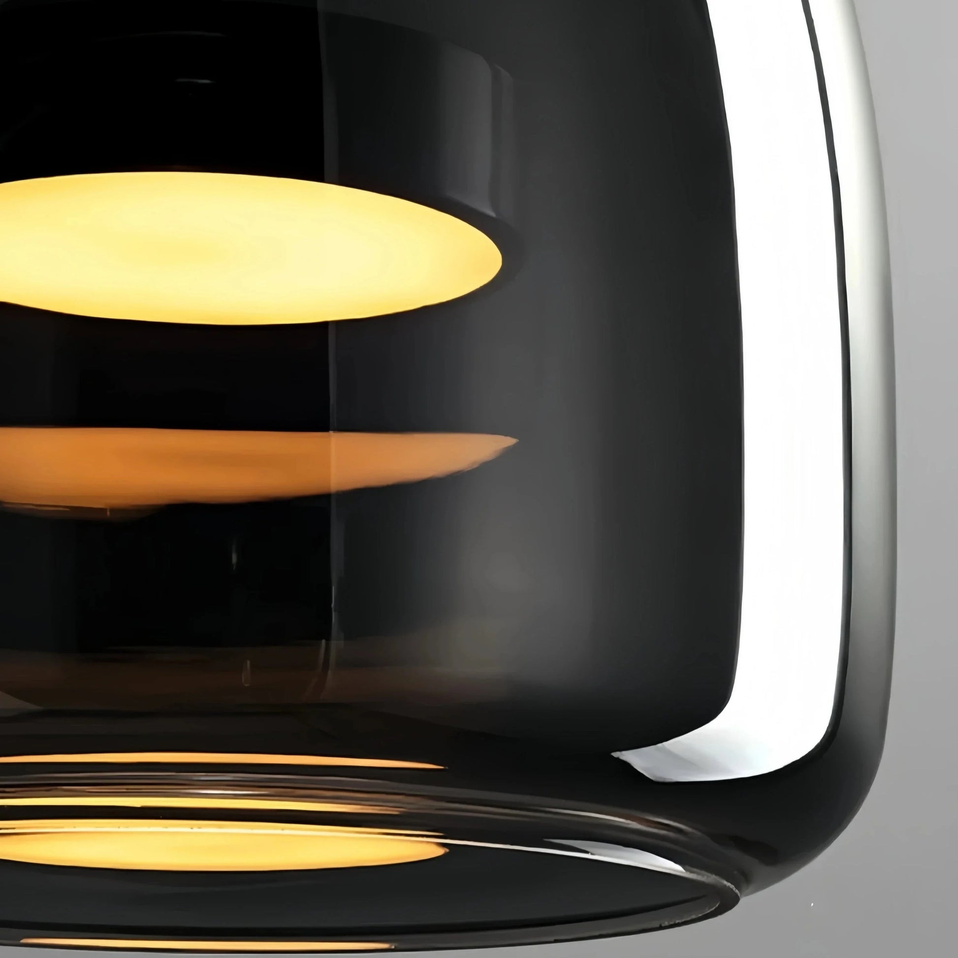Black and gold pendant lamp by Light My House with LED warm light and adjustable height, hanging from a ceiling fixture.
