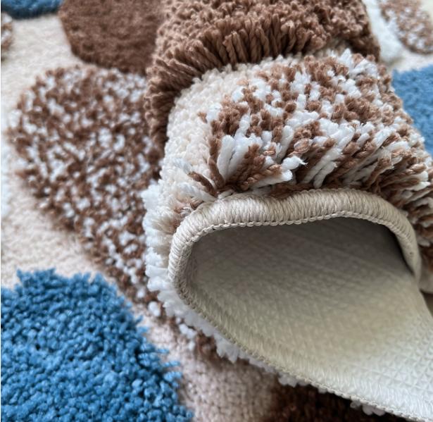 Pebble-style plush non-slip bathroom mat with rubber backing, soft and machine washable bath rug by DEPOT.