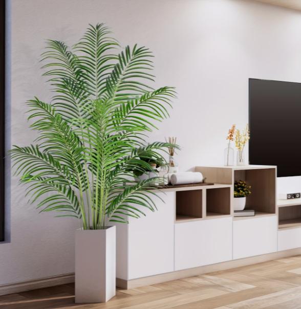 Large lifelike palm tree from DEPOT, indoor and outdoor tropical foliage for home and garden decor, shown in a garden setting