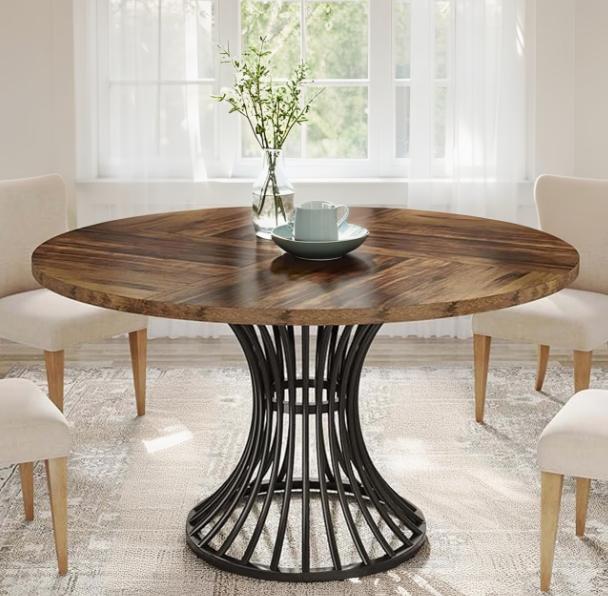 Round farmhouse dining table with a 47-inch wood top and elegant metal base, ideal for dining and living room settings.