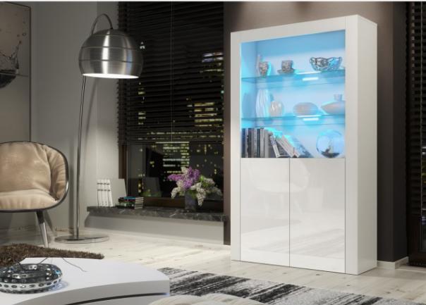 Modern interior with a white high-gloss cabinet displaying fish tanks, a floor lamp, and a cityscape view.