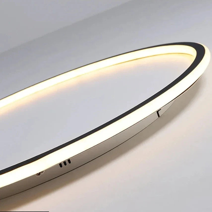 Dimmable LED ring flush mount chandelier in black and white, modern ceiling light with sleek design and ambient lighting.