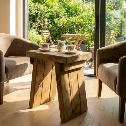 Small DIAN rustic wooden coffee table by Tribe Joinery with angled legs, featuring a natural wood finish and compact side table design.