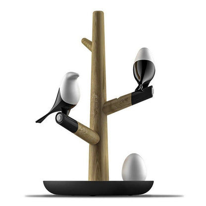 Lucky Bird LED night table lamp with wooden base, featuring two birds and eggs, illuminated and showcasing intelligent motion sensor.