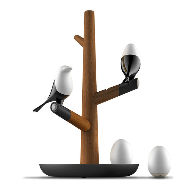 Lucky Bird LED night table lamp with wooden base, featuring two birds and eggs, motion sensor for living room or bedroom lighting.