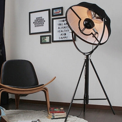 Industrial-style Satellite Studio Tripod Floor Lamp by Mira Sales, standing with adjustable tripod legs and a spotlight-style light.