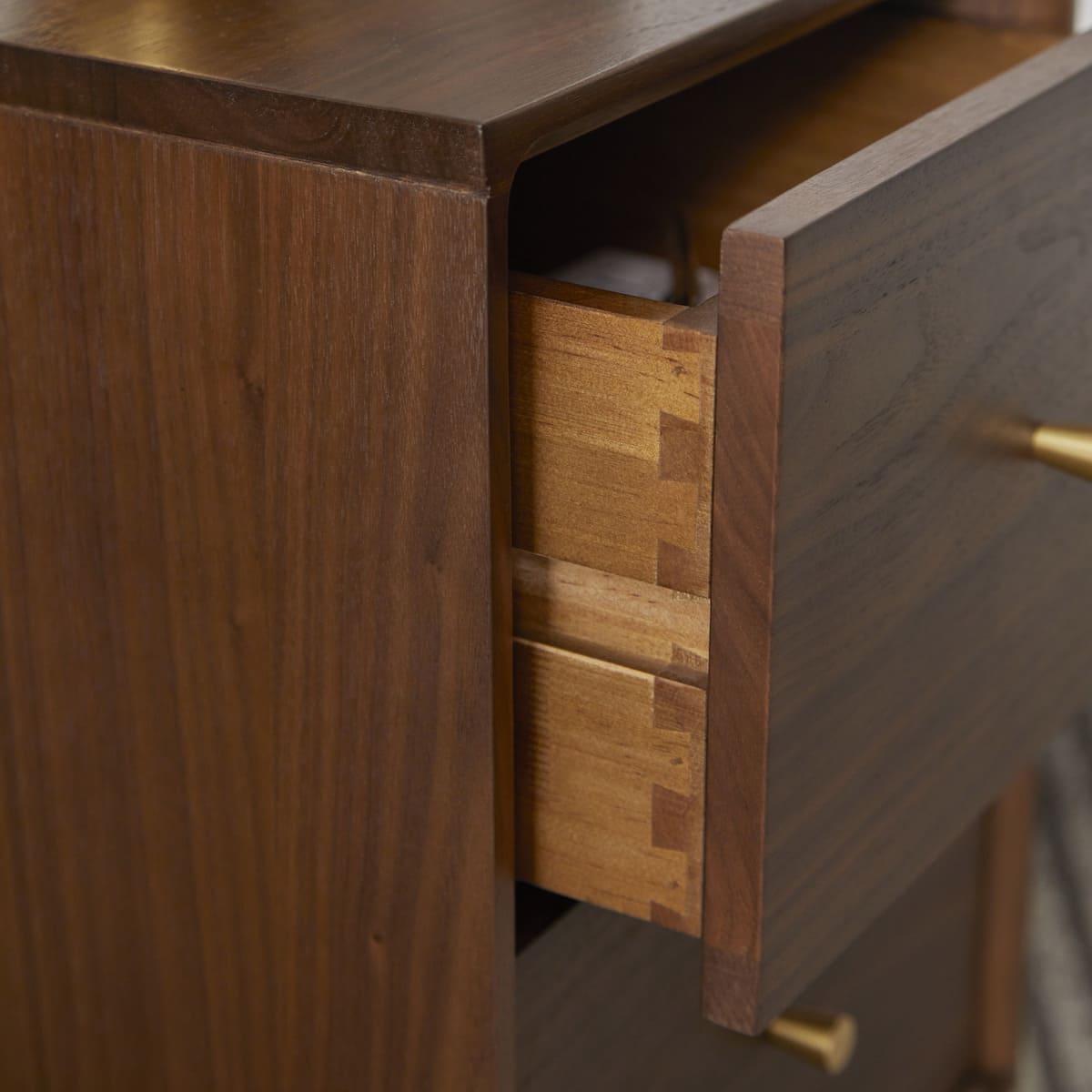 Fishe and Lilly Wright Narrow Walnut Bedside Table with sleek design and smooth wood finish, shown with a lamp and books.