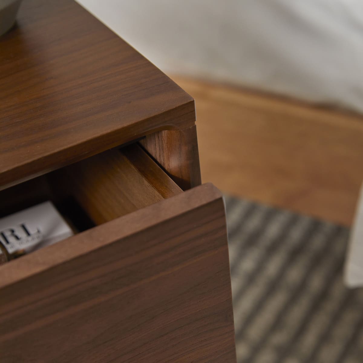 Fishe and Lilly Wright Narrow Walnut Bedside Table with a sleek design and compact storage space.