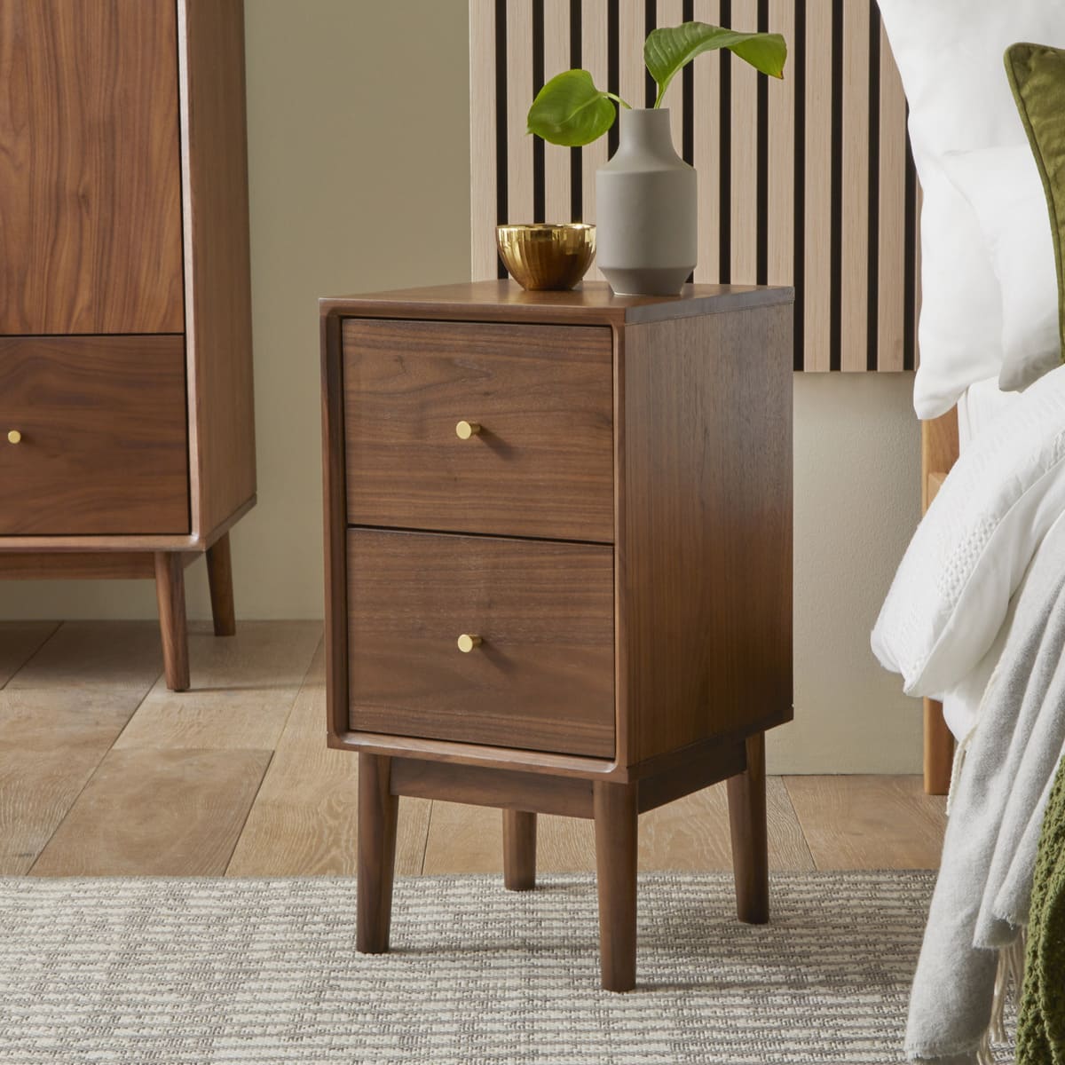 Fishe and Lilly Wright Narrow Walnut Bedside Table with a sleek design and a single drawer for bedside storage.