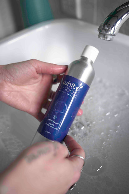 White Rabbit Organic Peppermint Face and Body Wash bottle with white and green packaging, highlighting natural ingredients and refreshing scent.