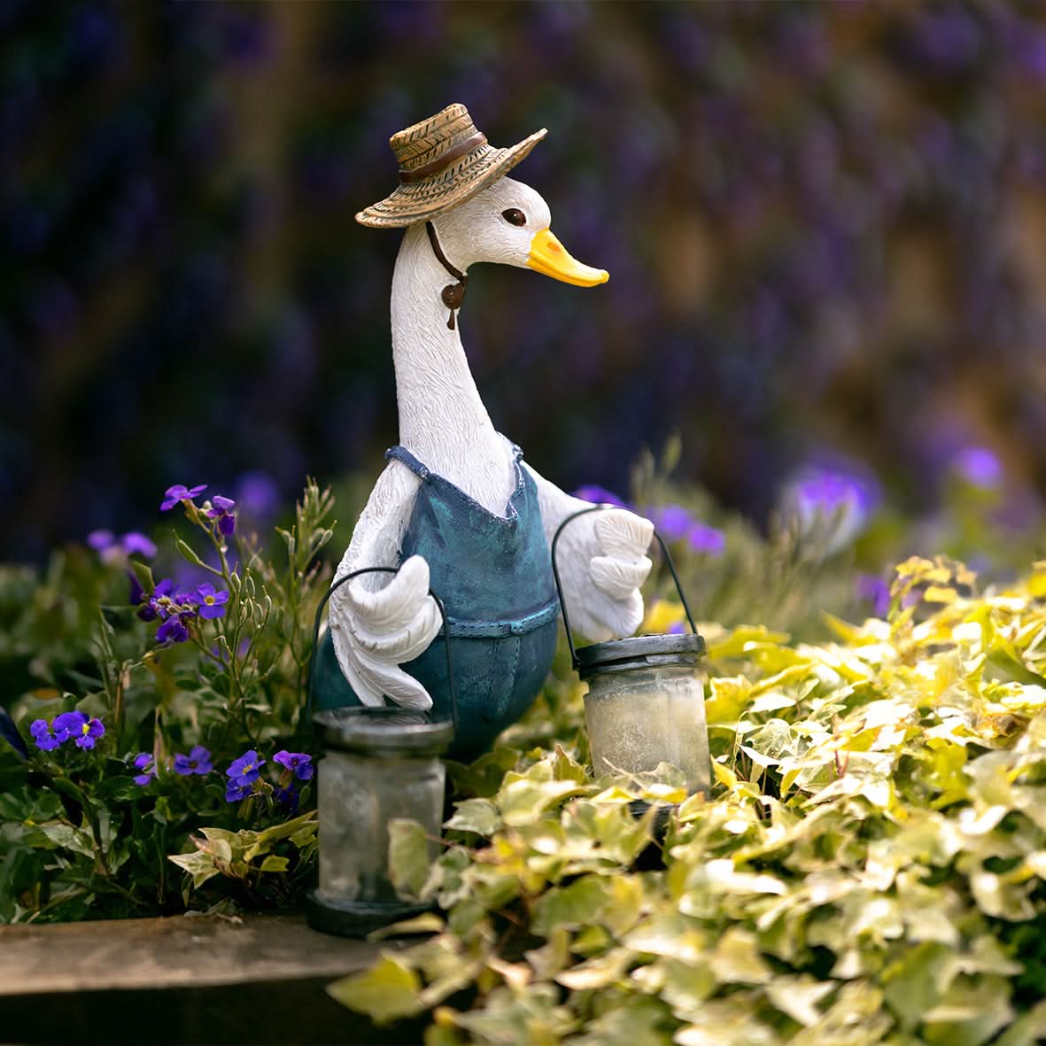 Weatherproof solar duck garden ornament with LED lantern, outdoor statue by Marco Paul, perfect for garden decor.