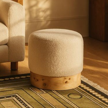 Orsina Mota burl wood and cream boucle round pouffe stool with stylish design and plush upholstery.