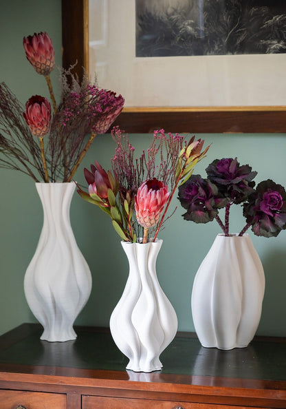 Tall white ceramic vase with twisted design from Casa by Josephine Jenno, ideal for modern home decor.