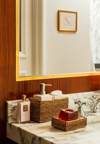 Wicker rattan bathroom accessories set by Casa, including a wash basin and storage basket, in natural woven design.