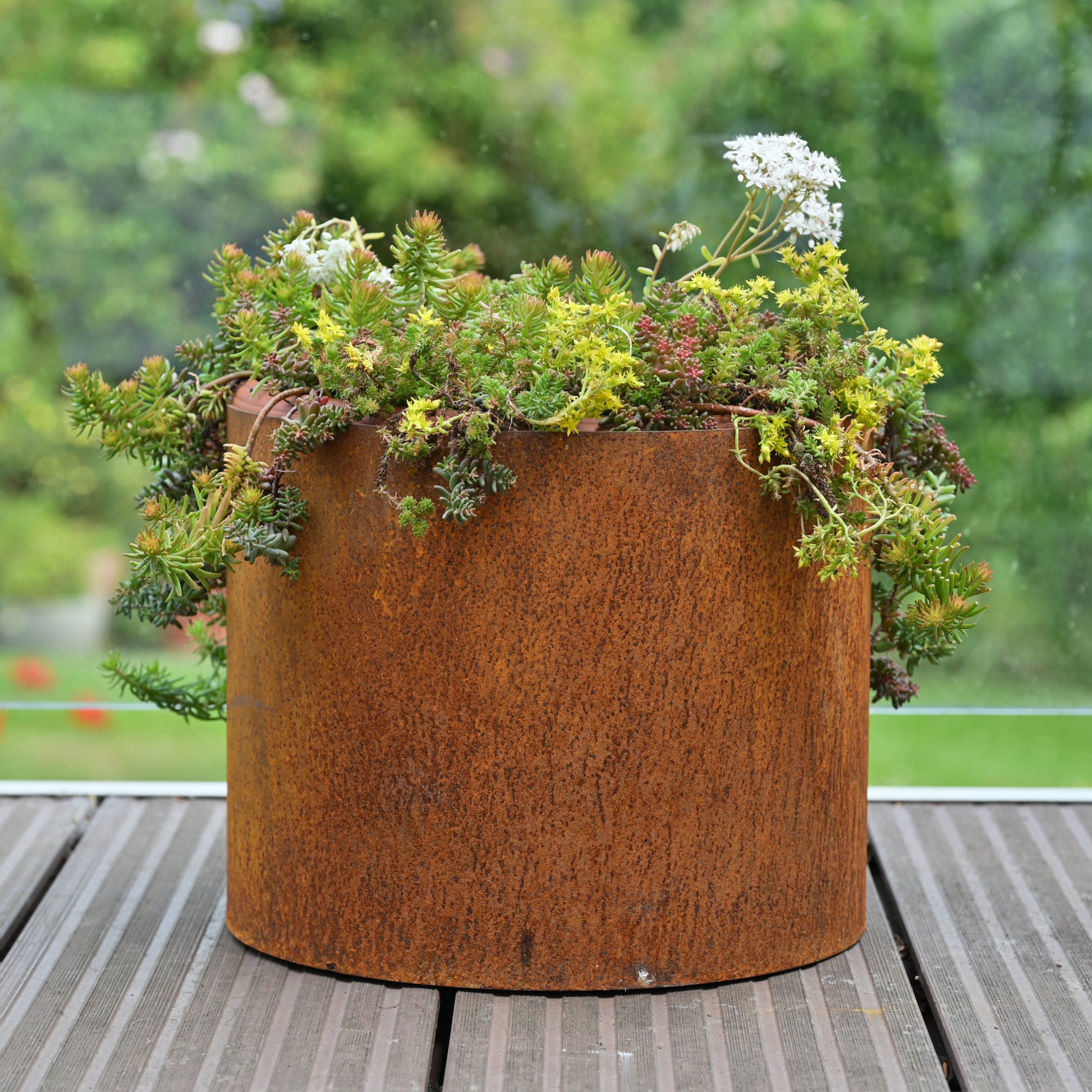 Rusty metal plant pot from SavageWorksUK, a garden planter with a weathered, rustic appearance suitable for outdoor gardening.