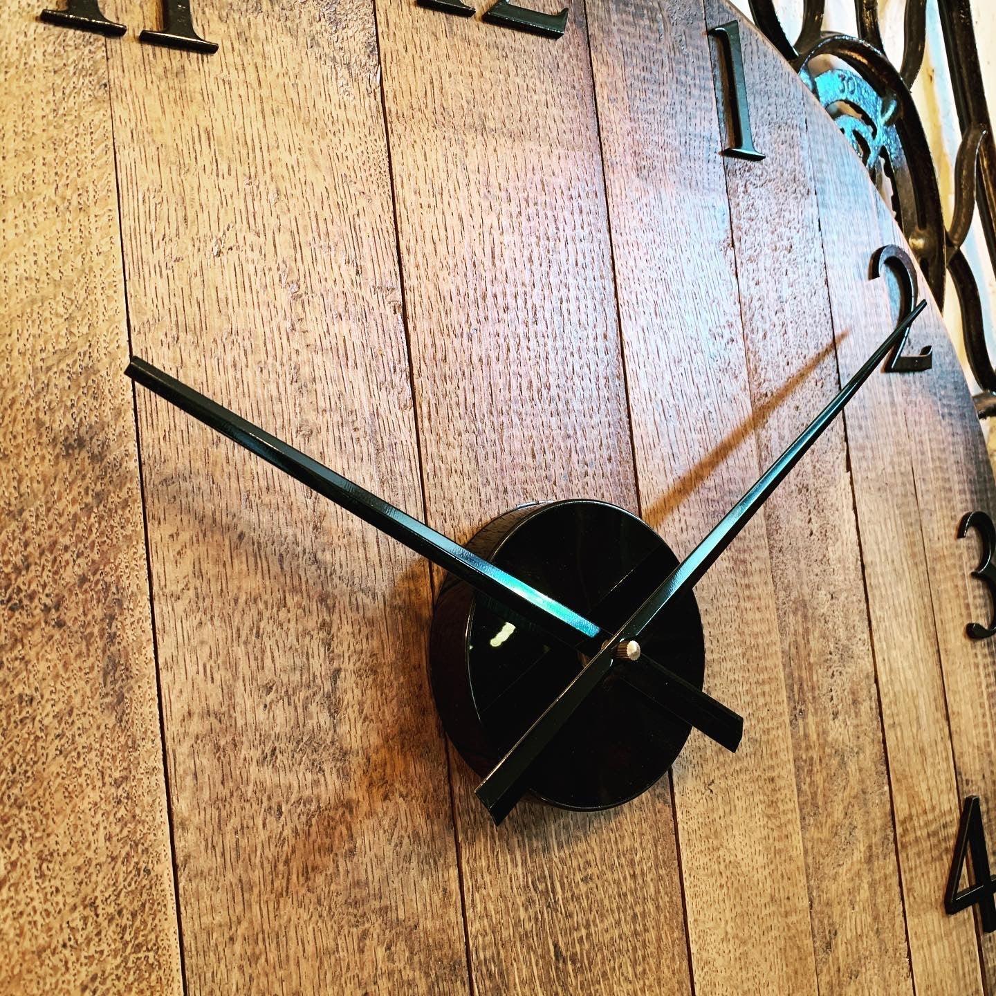 Oak finish whiskey barrel clock made by MooBoo Home, showcasing a rustic design and vintage-inspired timepiece.