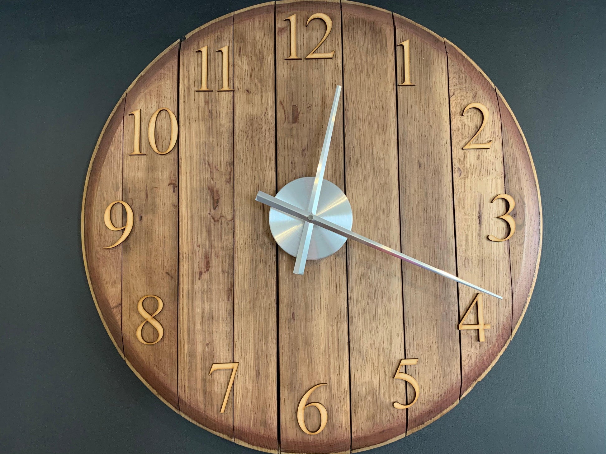 Oak finish whiskey barrel clock by MooBoo Home, featuring a rustic design with visible wood grain and vintage-style clock face.