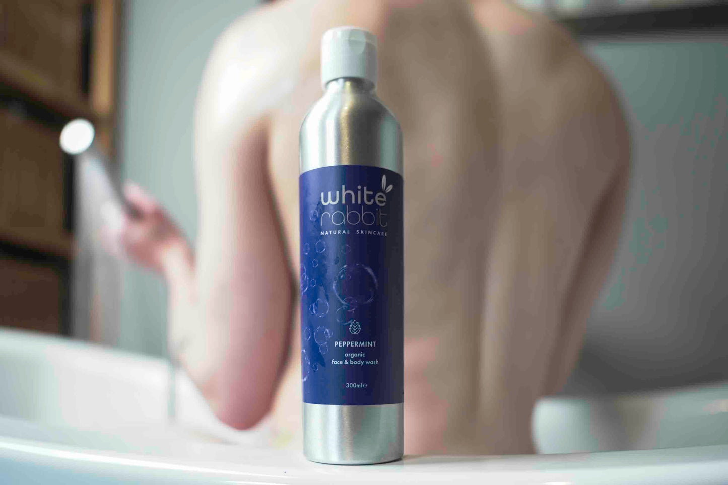 White Rabbit Organic Peppermint Face and Body Wash bottle with label, featuring white packaging and peppermint imagery.